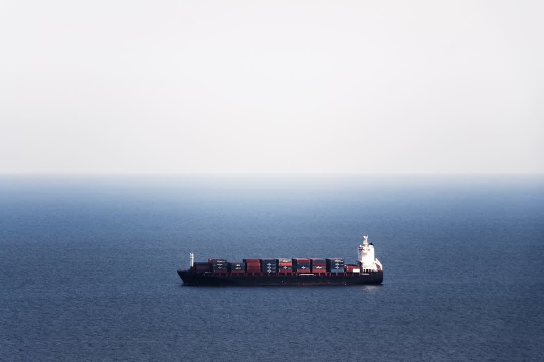 Container ship at the deep-water port of Prince Rupert under overcast northern skies