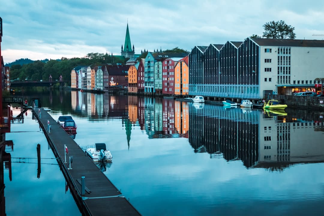 Colourful heritage buildings of Cow Bay reflected in wet pavement after rain