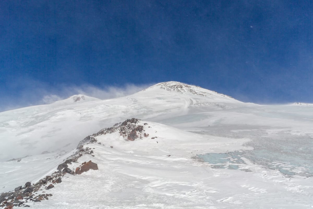 Old Soviet pendulum cable car ascending toward the snowfields of Mount Elbrus above the Baksan Valley, Russia