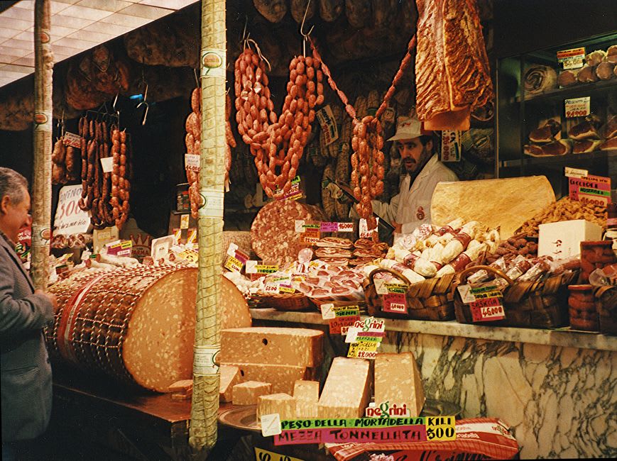 Wheels of Pont-l'Évêque and Livarot cheese displayed at the Saturday market in Lisieux