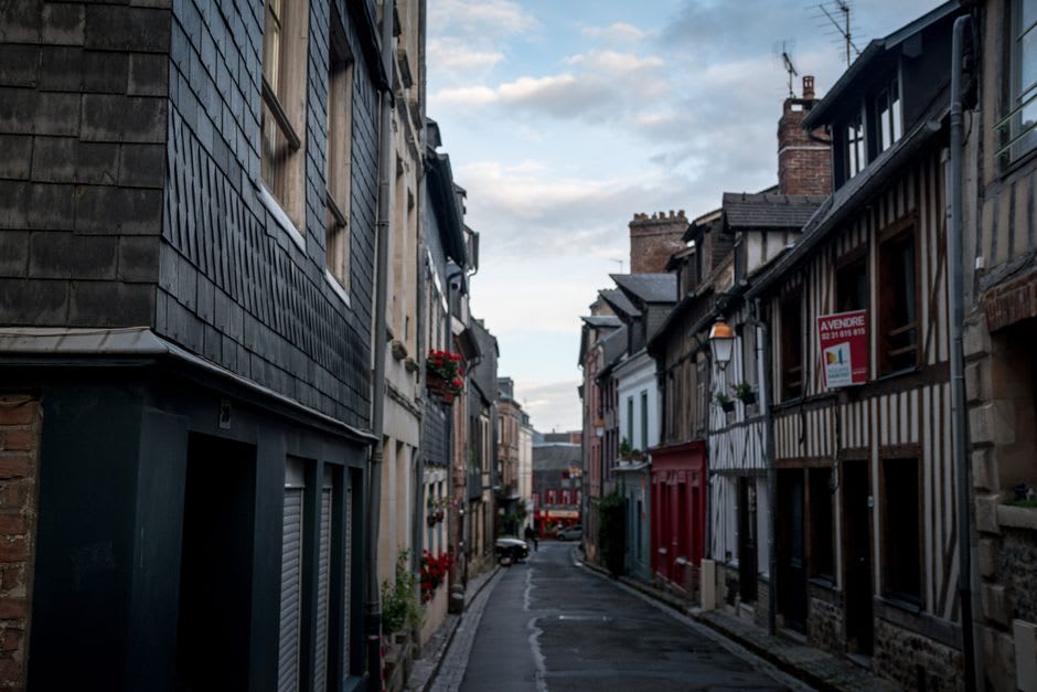 A narrow granite street in old Roscoff lined with 16th-century merchant houses built with onion trade money