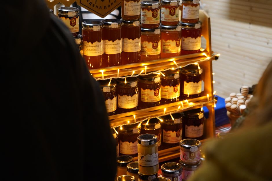 A stallholder's table piled with jars of lavender honey and blocks of nougat at the Wednesday market in Sault