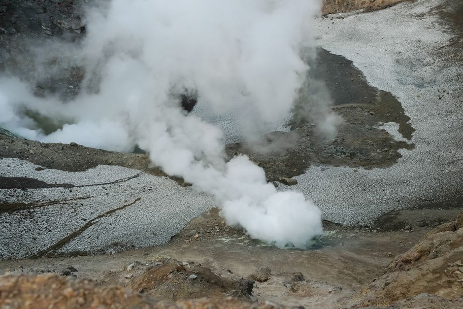Steam rising from cracks in the reddish lava fields near Volcán Chico on Sierra Negra