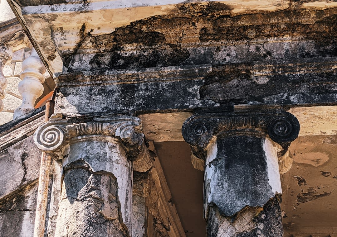 The weathered stone lintel and columns of the ancient synagogue ruins at Gush Halav near Jish