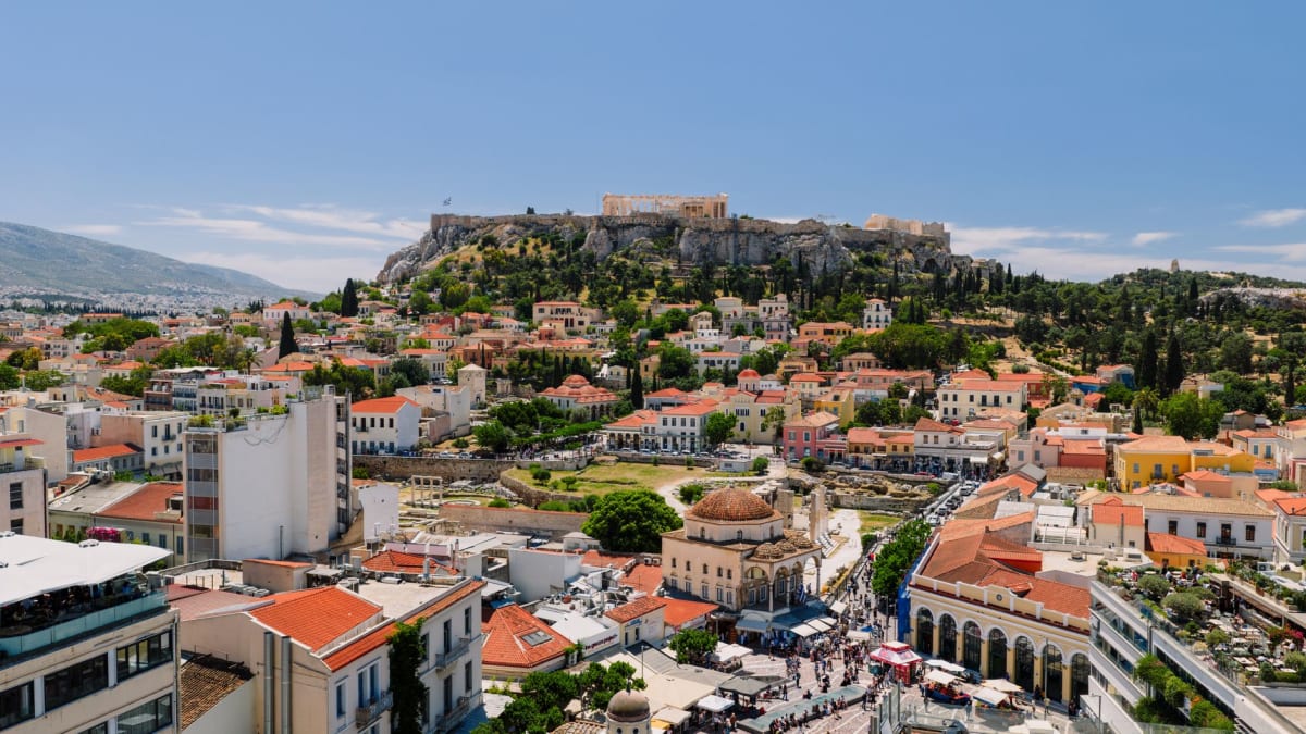 Busy Monastiraki Square with the Acropolis rising behind the rooftops