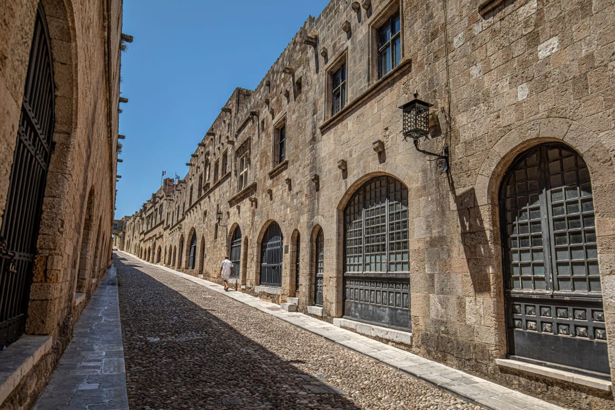 Medieval stone street with arches and towers in Rhodes Old Town