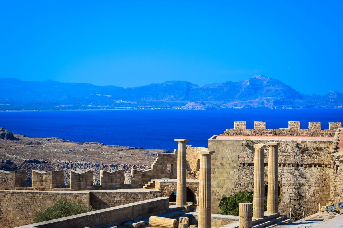 The white village of Lindos with its clifftop acropolis and turquoise bay