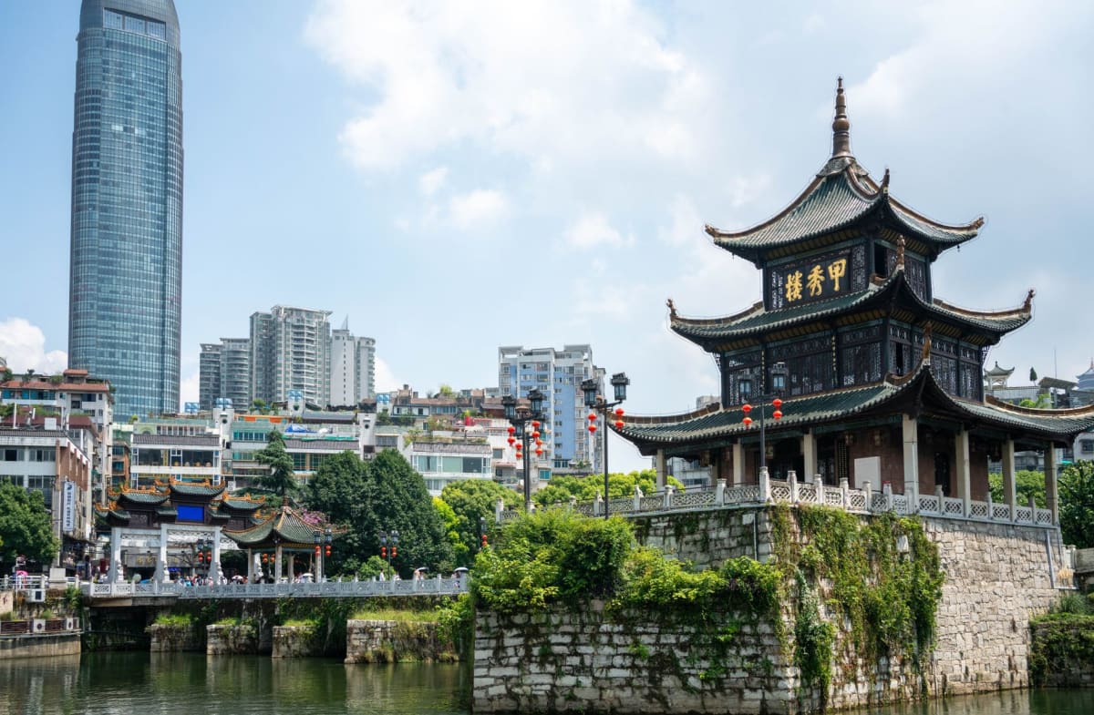 Rongjiang Wednesday market in full flow, dozens of ethnic minority women trading goods along the river embankment