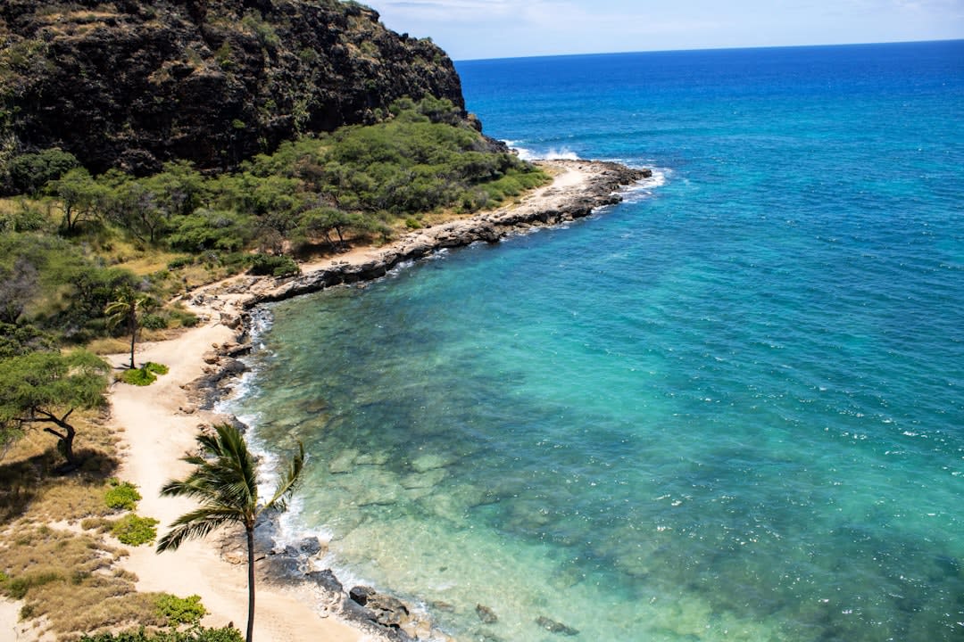 View along the start of the Kalalau Trail above Ke'e Beach looking out over the Nā Pali Coast cliffs