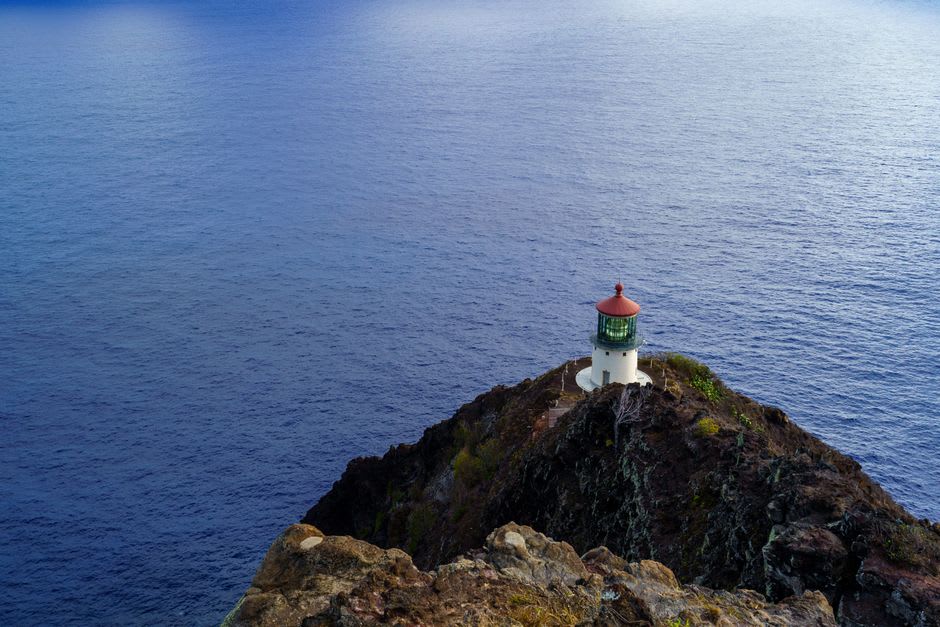 Paved Makapu'u lighthouse trail winding along a cliff above the Pacific with Rabbit Island offshore