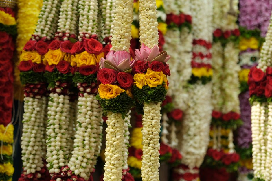 Jasmine flower vendors sorting fragrant Madurai Malli buds at a pre-dawn flower market
