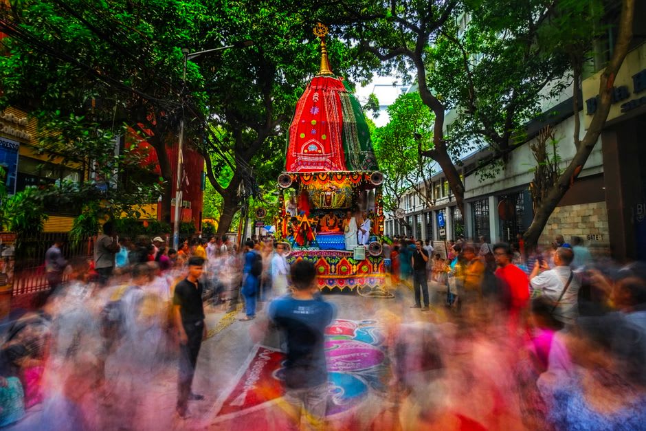 The towering wooden chariots of Rath Yatra being pulled through Puri's Grand Road by crowds