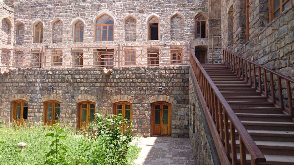 The carved stone entrance portal of St. Stepanos Monastery with Armenian khachkar cross-stones set into the wall