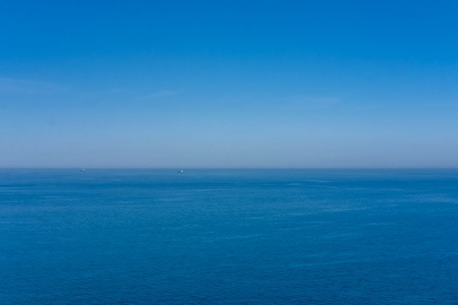 View across the strait from Iwaishima toward the mainland shore where the disputed nuclear plant has been proposed