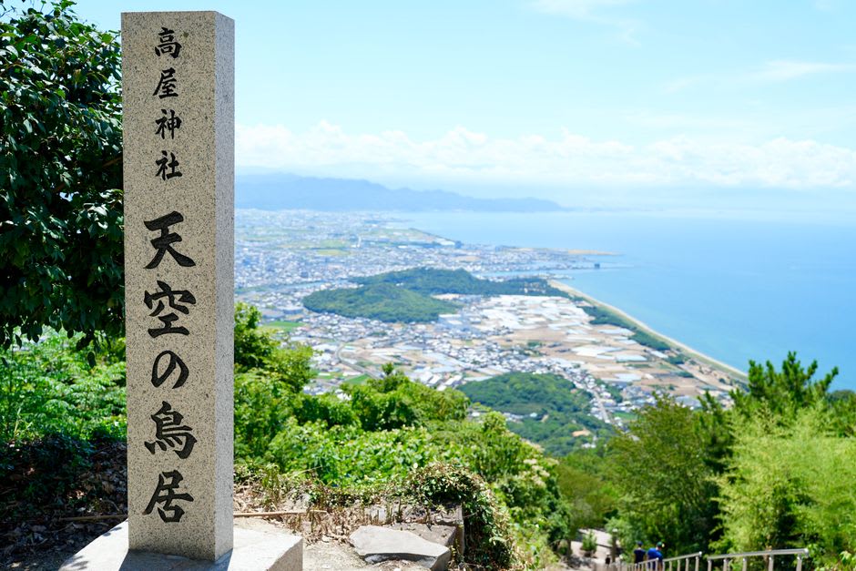 A row of old wooden shops and a tea house along the stone approach to Konpira-san in Kotohira, lanterns and hanging goods