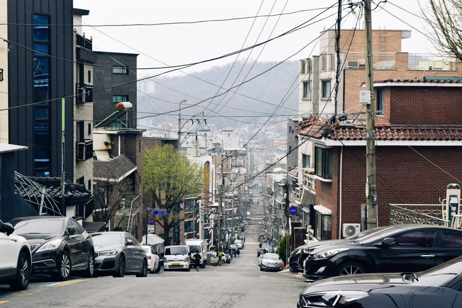 Una calle estrecha en la ladera de Kure bordeada de escaparates antiguos y viviendas de la era de los estibadores