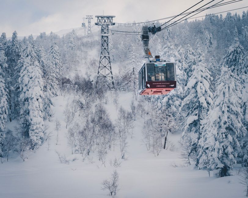Single-seat chairlift rising toward the ridgeline of Mount Tsurugi