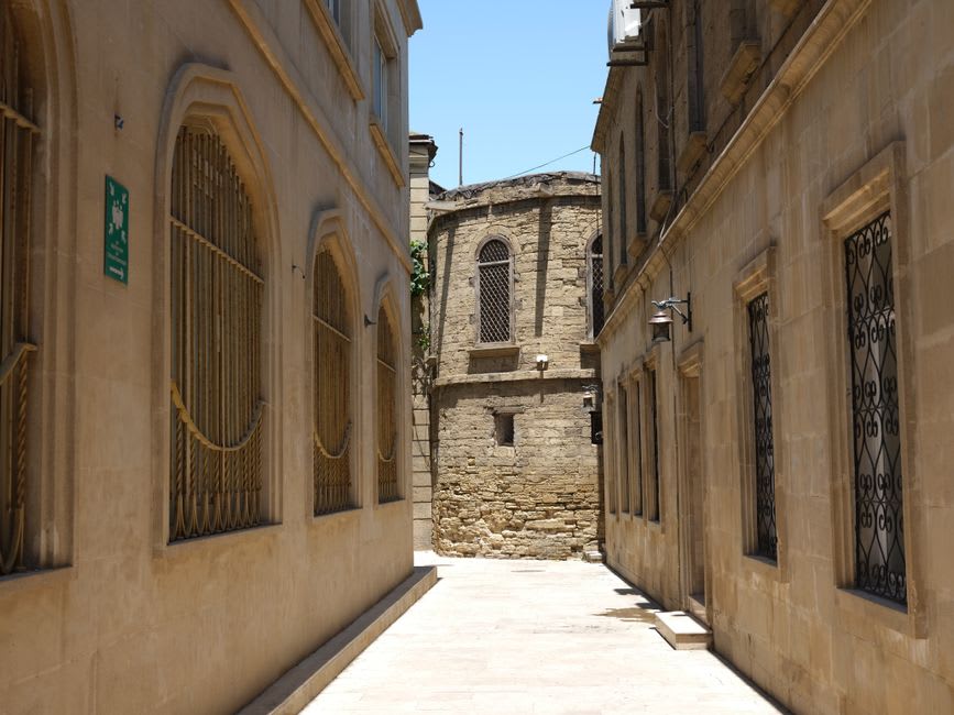 A narrow stone alley in Deir el Qamar lined with ochre houses and wooden shutters