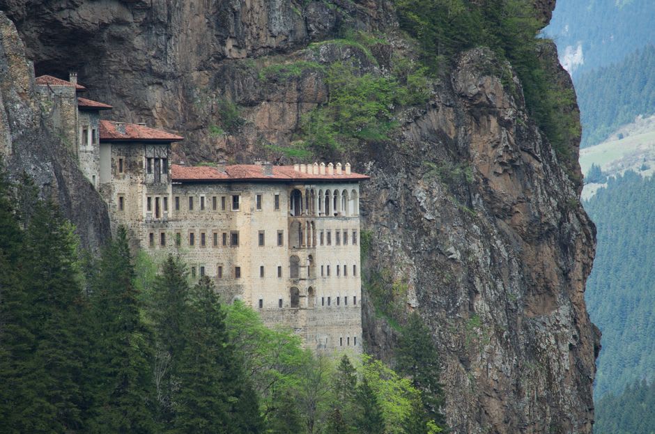 A stone hermitage chapel carved into the cliff face of the Qadisha Valley