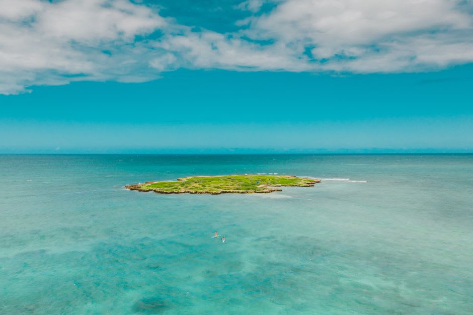 An uninhabited islet on Ailuk's lagoon, a narrow strip of white sand and coconut palms surrounded by shallow turquoise water
