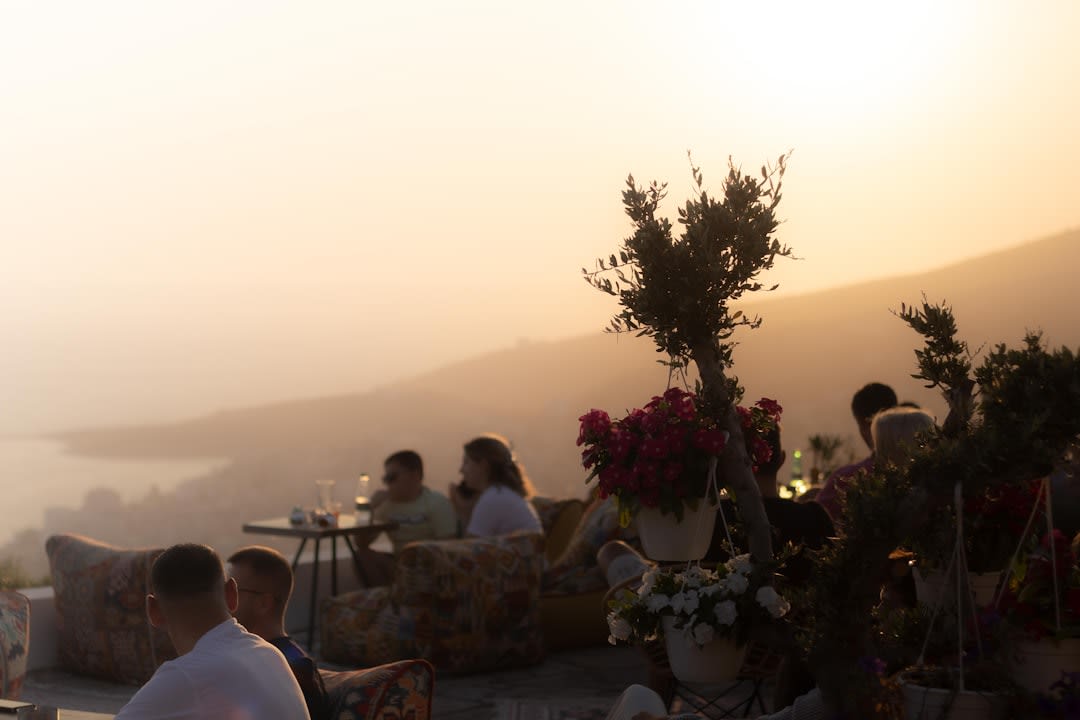 Outdoor winery restaurant table set with wine glasses and the Andes mountains visible beyond the vines