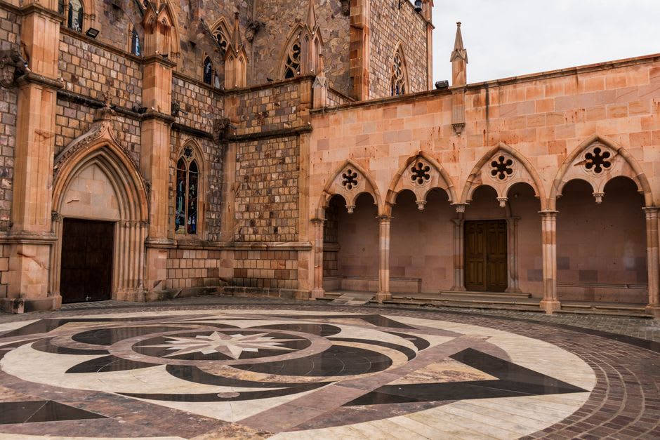 The interior cloister of Acolman, arched stone walkways framing a quiet courtyard