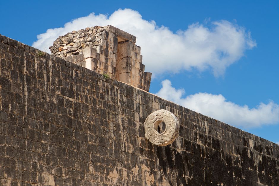 The ballcourt at Teotenango with its stone rings intact, flanked by low platform walls, the Toluca Valley spread below in the background