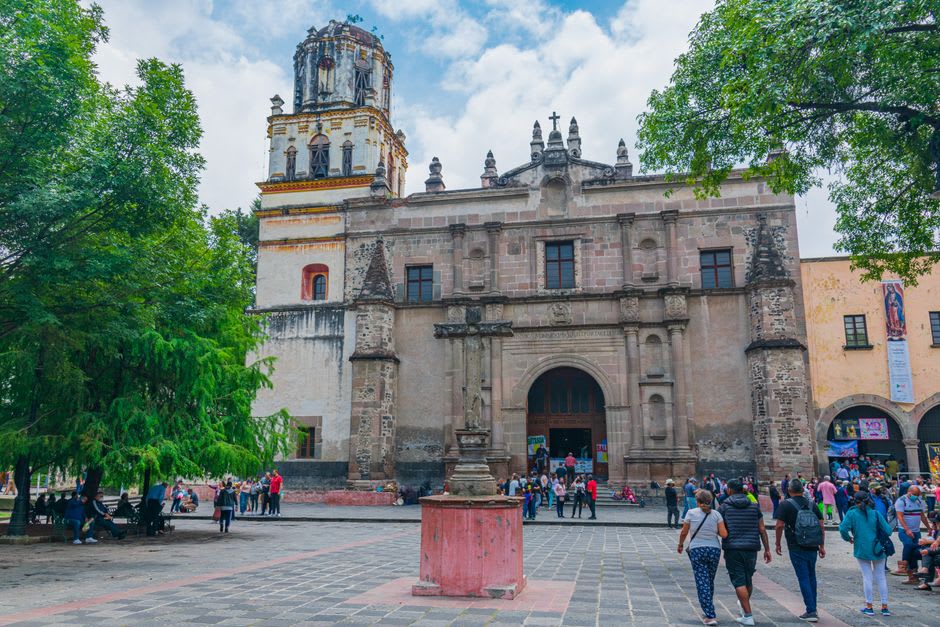 The three arched bays of Tlalmanalco's open chapel opening onto the broad atrium with the volcanic peaks beyond