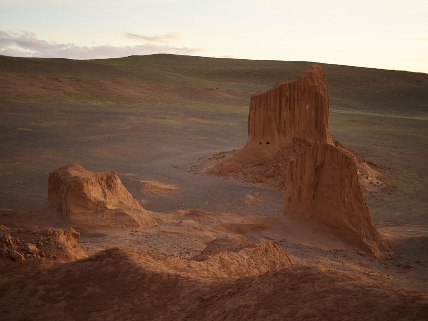 A wide, empty stretch of Gobi desert badlands at sunset near the Nemegt Basin excavation sites