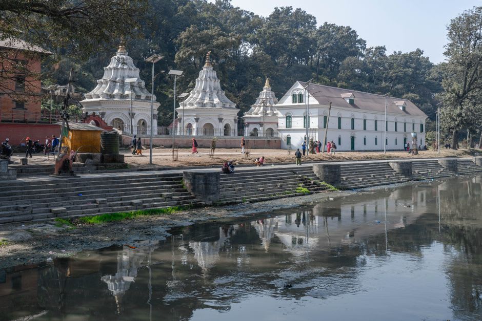 Devotees offering flowers and vermillion powder at the white-domed Bindhyabasini Temple courtyard in Pokhara's old bazaar
