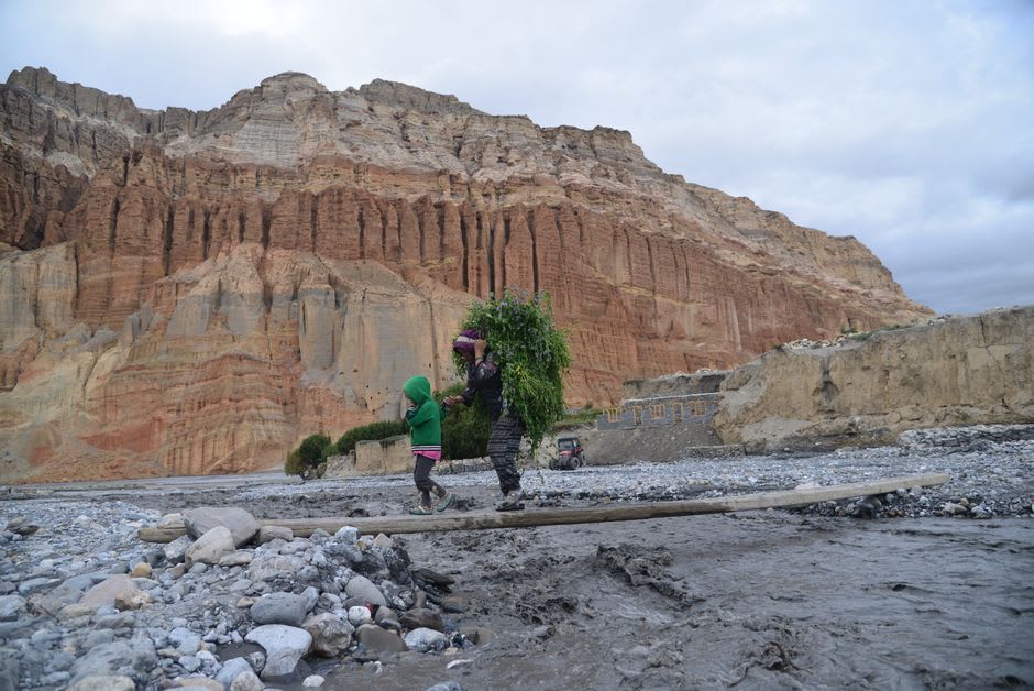 Natural rock tunnel along the Kali Gandaki riverbed near Chhusang with a mule train passing through in single file
