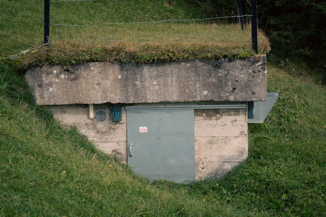 Concrete German bunker at Pointe du Hoc with grass growing over the bomb craters around it