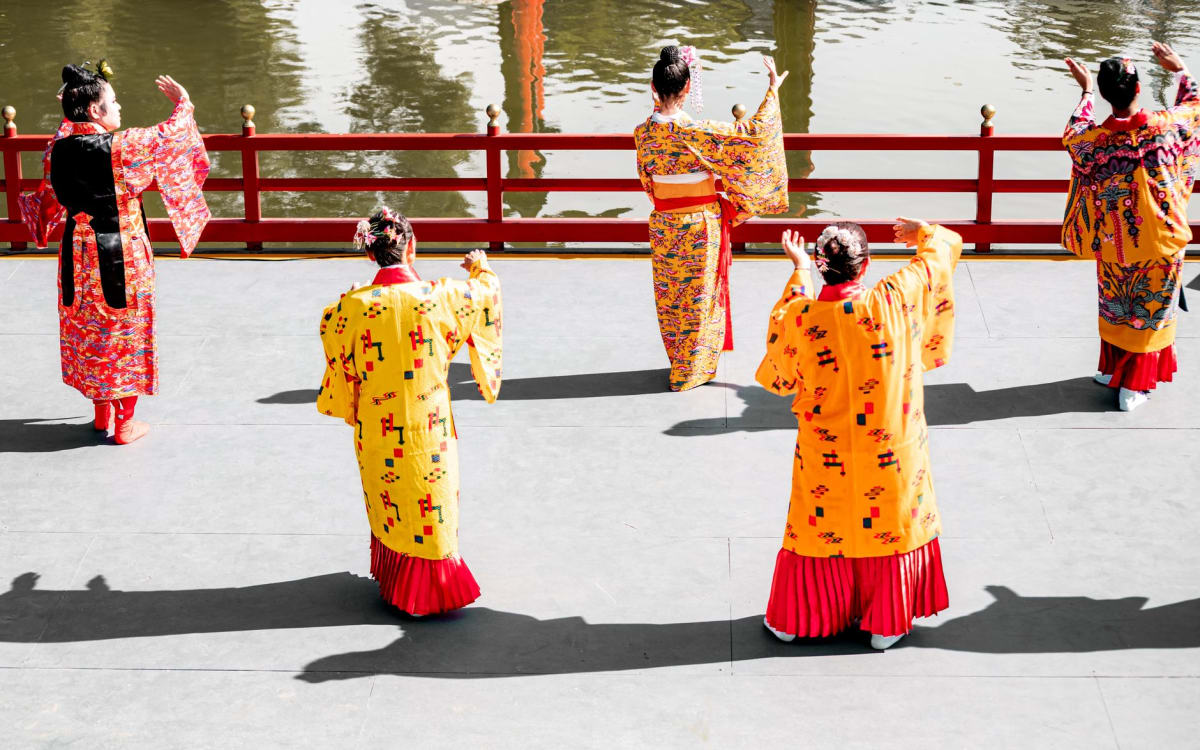 The Seiden main hall of Shuri Castle, crimson lacquer gleaming under afternoon sun, Naha, Okinawa