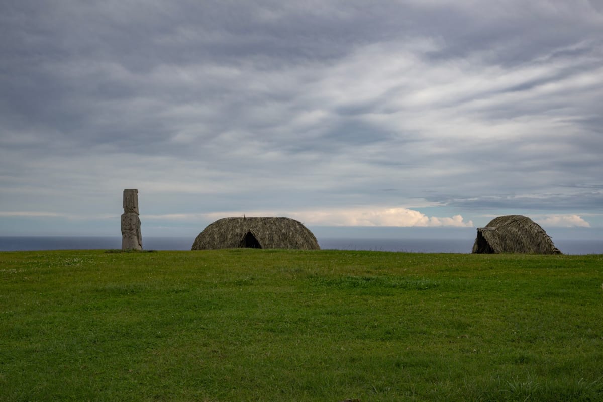 The Loch of Stenness in early evening light with the standing stones beyond and low hills on the far shore