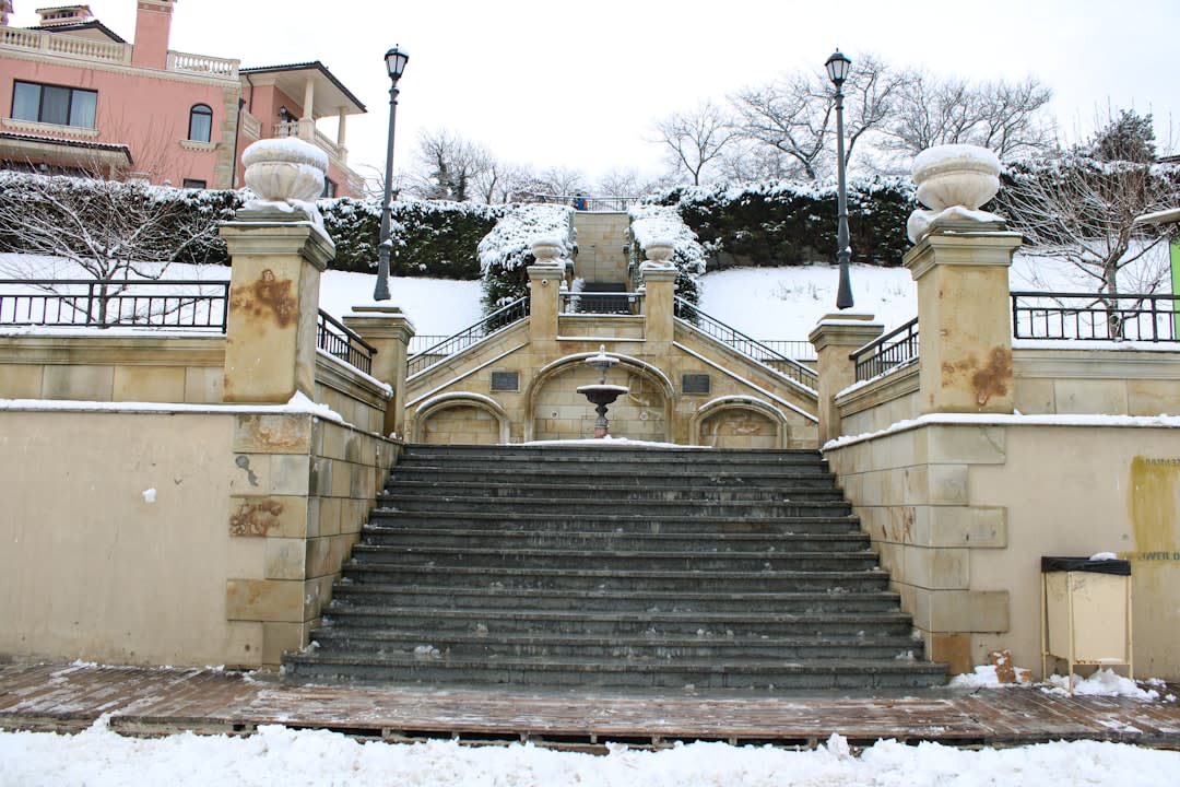 Pilgrims and tourists ascending the ornate baroque staircase of Bom Jesus do Monte past sculpted fountains