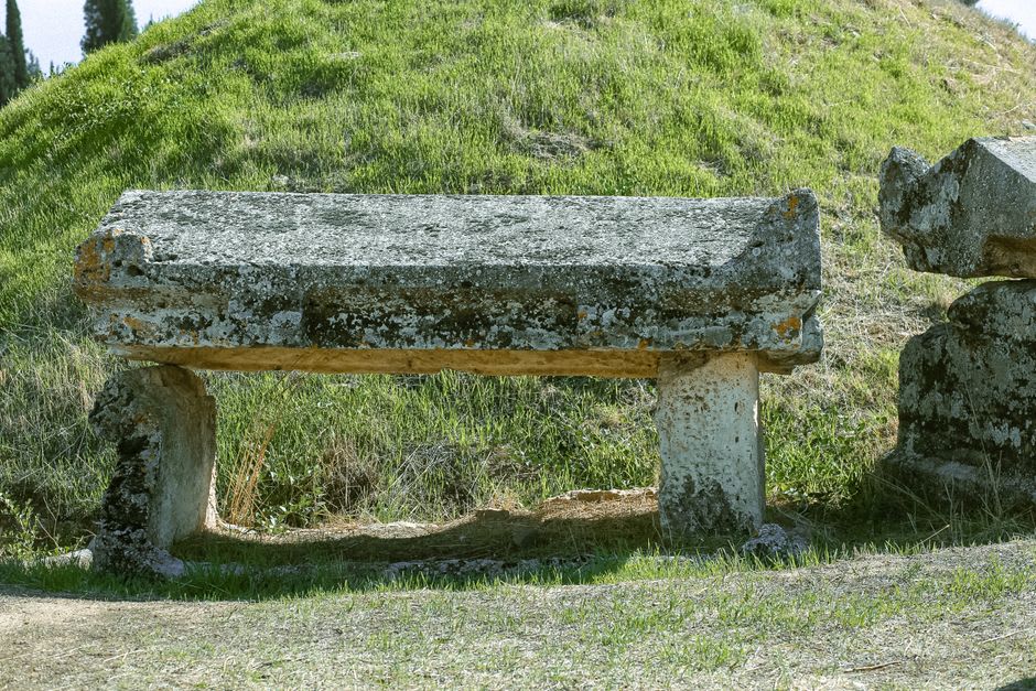 Ancient Roman milestone embedded in the ground beside the medieval castle walls of Linhares da Beira