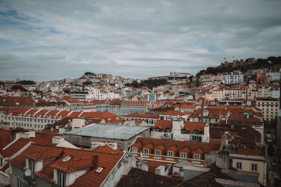 View from Linhares da Beira's castle keep over granite rooftops toward the peaks of the Serra da Estrela