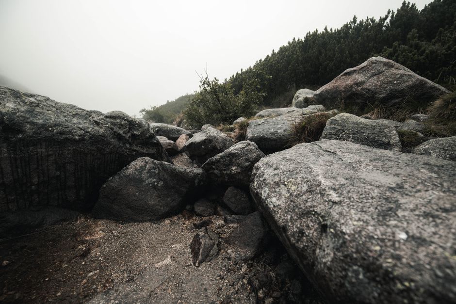 Alpine meadow scattered with granite boulders along the glacial Zêzere valley trail above Manteigas