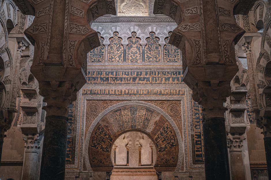 Interior of Mértola's church showing the horseshoe arches and mihrab from its original mosque structure