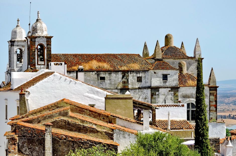Whitewashed baroque church facade standing out against the gray schist houses of Piódão