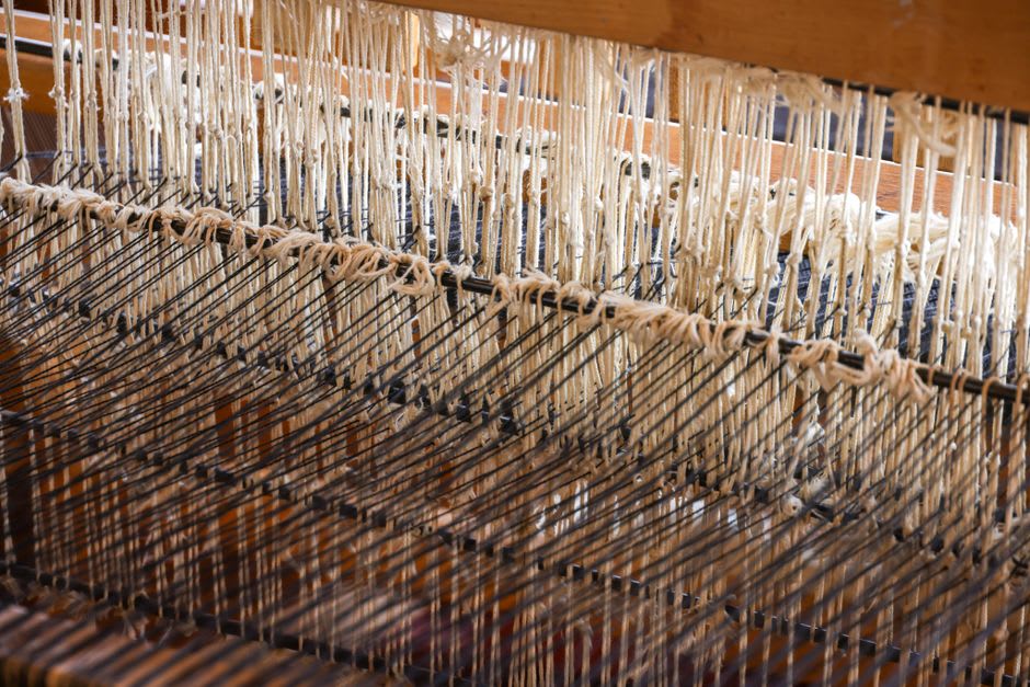 Detail of a hand-woven wool tapestry at the Portalegre tapestry museum showing intricate stitchwork
