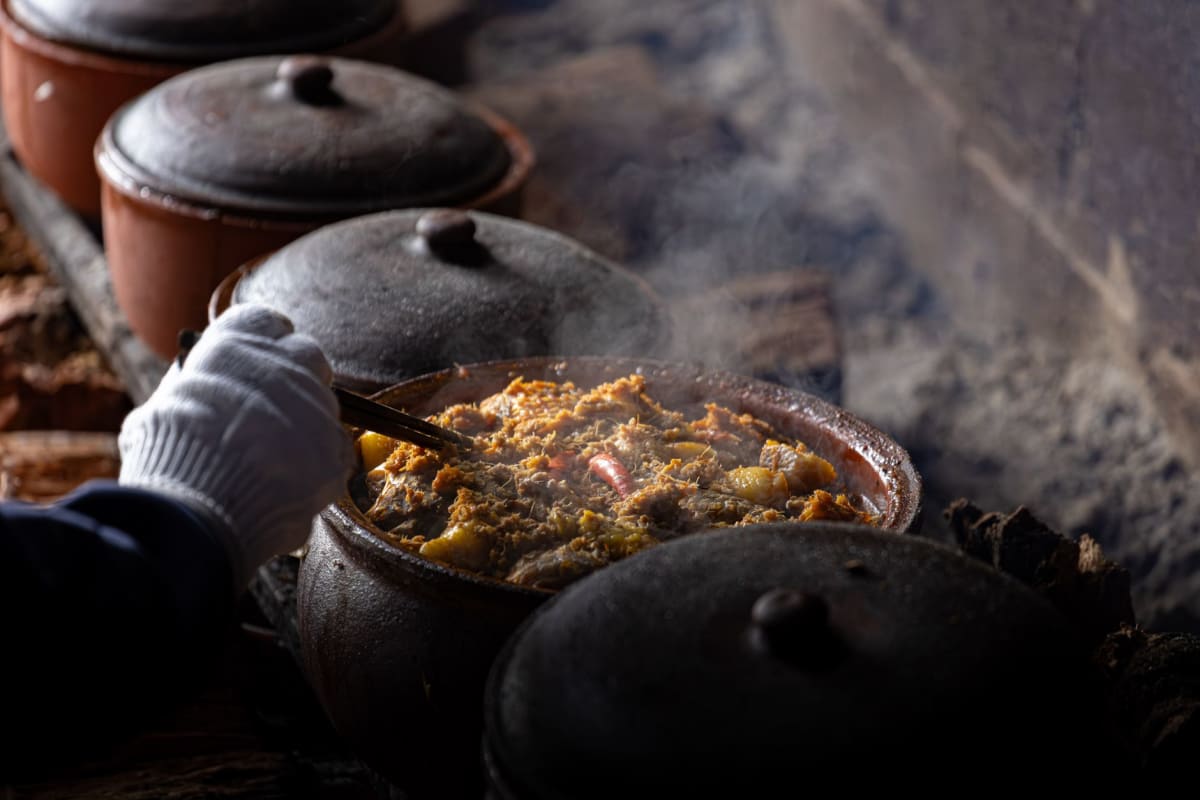 Clay pot of chanfana at a village esplanade in Serra da Lousã, bread on the side
