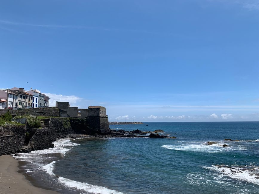 Statue and harbor view at Vila do Porto commemorating Columbus's 1493 landing on Santa Maria