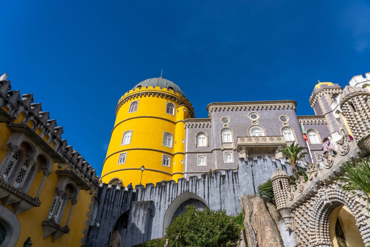 Pena Palace colorful towers and battlements rising above Sintra forest