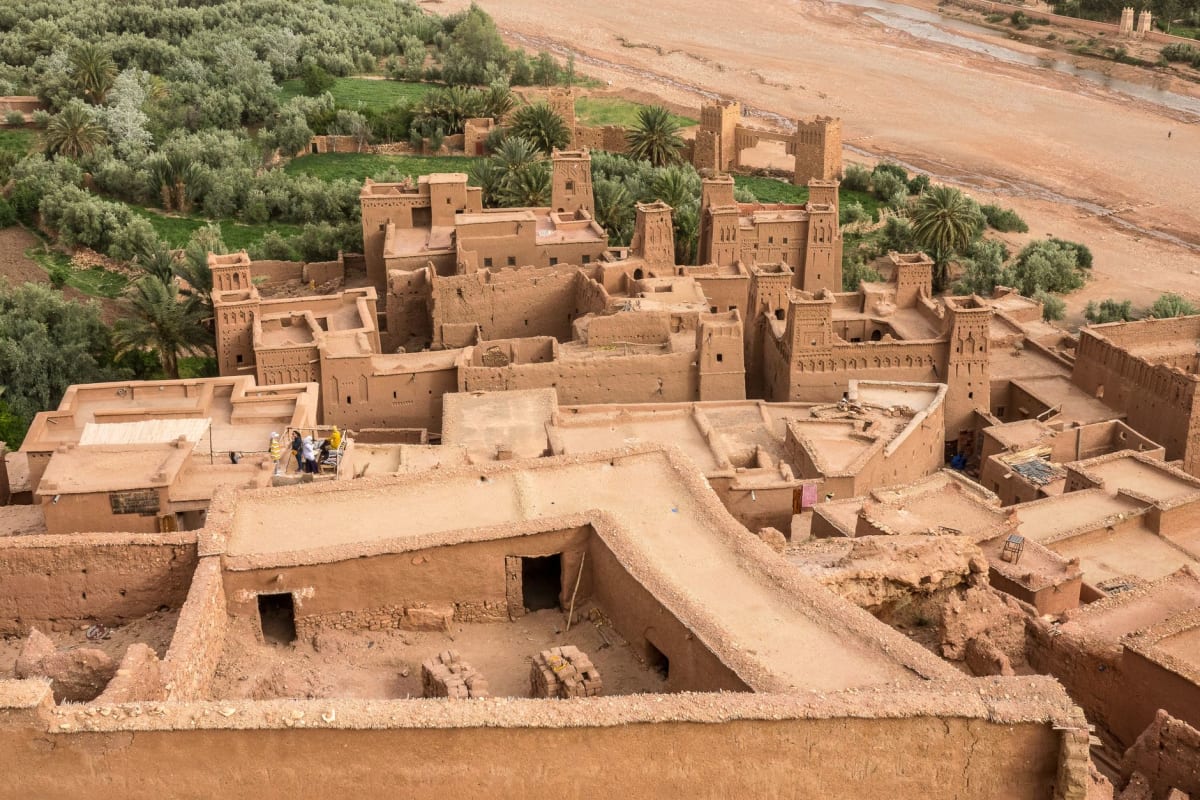 Tuareg silversmith's courtyard in Agadez, silver crosses and tools spread across a woven mat