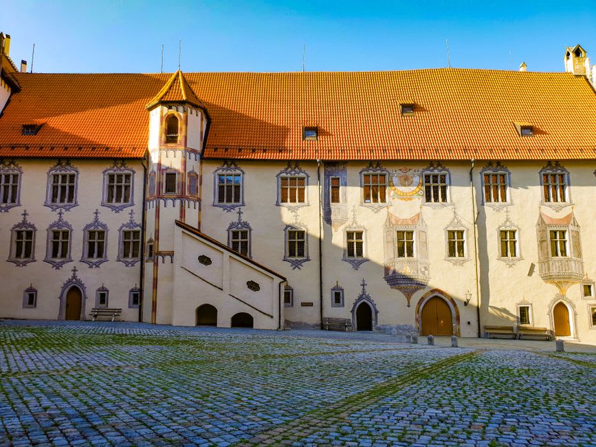 Narrow cobbled street lined with pastel medieval houses in Kremnica