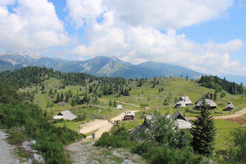 Wide open alpine grassland of Menina Planina with a single shepherd hut against a broad sky