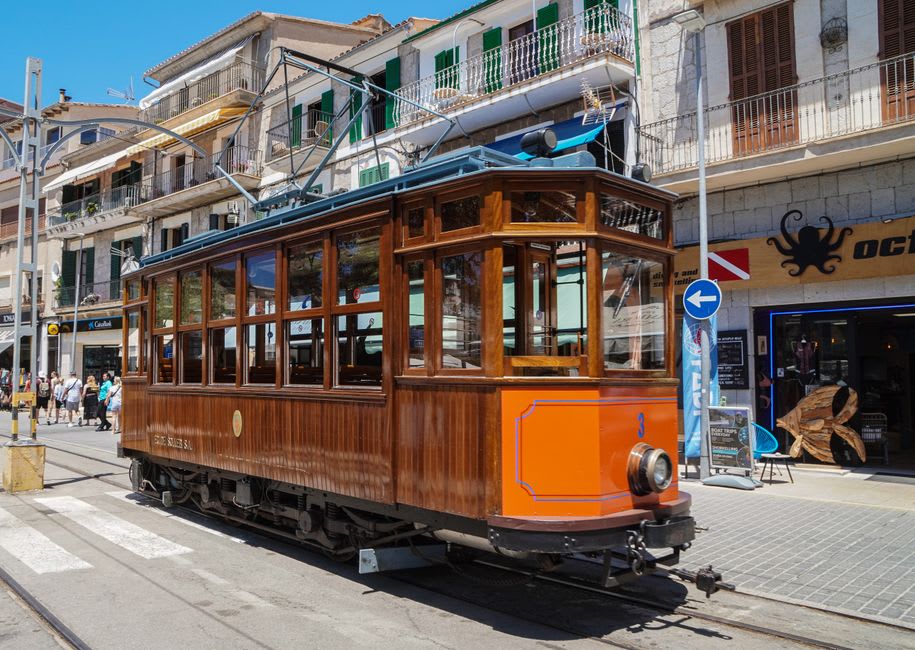 Sant Bartomeu church's Art Nouveau facade in Sóller's main square with the vintage tram passing in front