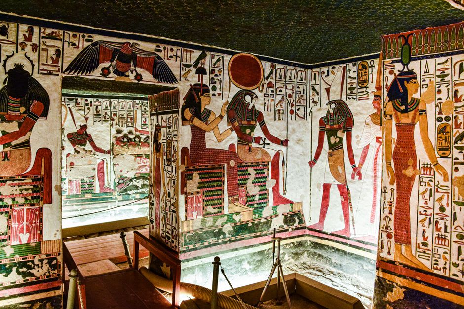 Interior burial chamber at Nuri near Karima, faded painted relief and hieroglyphic carvings visible by torchlight on stone walls