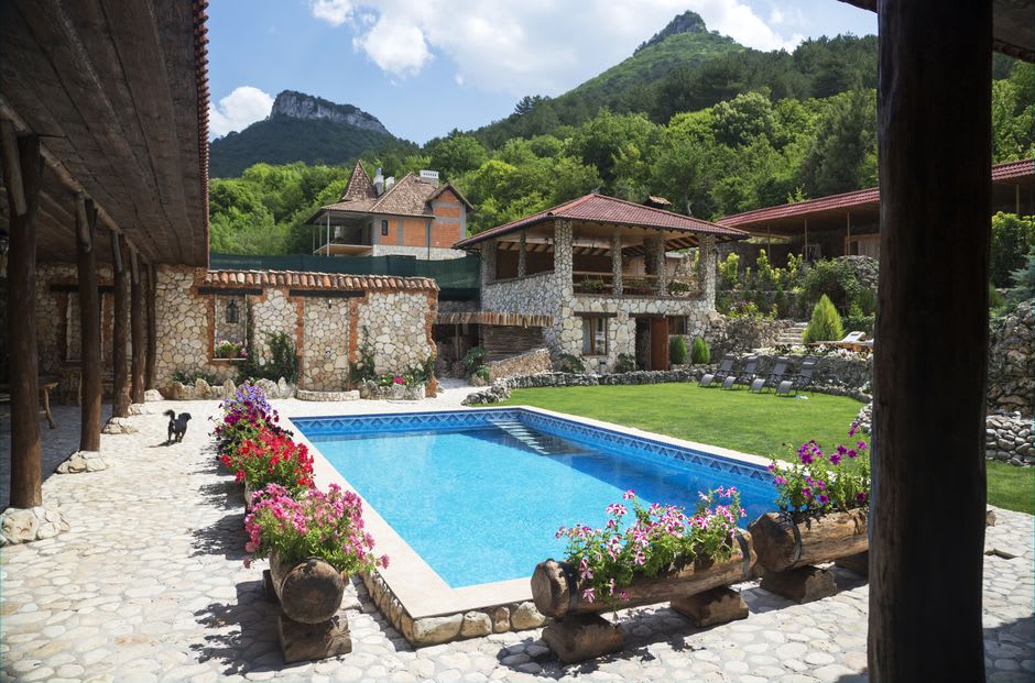 Apricot and walnut trees shading a guesthouse courtyard above the Panj River gorge